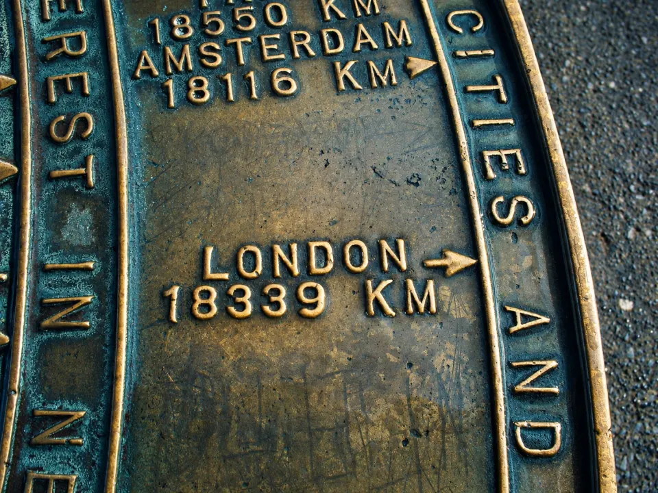 A brass distance marker in New Zealand reading London 18,339 km